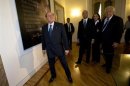 Berlusconi stands inside the new headquarters of his re-launched original political party, Forza Italia, in Rome
