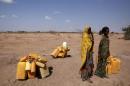 Woman wait to collect water in the drought stricken Somali region in Ethiopia