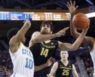 Oregon forward Arsalan Kazemi (14) shoots as UCLA guard Larry Drew II (10) defends in the first half of an NCAA college basketball game in Los Angeles, Saturday, Jan. 19, 2013. (AP Photo/Reed Saxon)