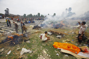 Nepalese people gather to cremate family members who &hellip;