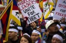Protesters chant and hold placards as they take part in a solidarity march from the Chinese Consulate to the United Nations Headquarters in support of Tibet in New York