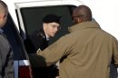 Army Pfc. Bradley Manning steps out of a security vehicle as he is escorted into a courthouse in Fort Meade, Md., Thursday, Nov. 29, 2012, for a pretrial hearing. Manning is charged with aiding the enemy by causing hundreds of thousands of classified documents to be published on the secret-sharing website WikiLeaks. (AP Photo/Patrick Semansky)