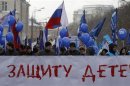 People march during a rally in defence of Russian children in Moscow