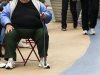 An overweight woman sits on a chair in Times Square in New York