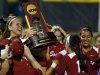 Oklahoma's Keilani Ricketts, left, holds the championship trophy after Oklahoma defeated Tennessee in the second game of the best of three Women's College World Series NCAA softball championship series in Oklahoma City, Tuesday, June 4, 2013. Oklahoma won the game 4-0 and the best of three series in two games.(AP Photo/Sue Ogrocki)