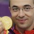 Romania's Alin George Moldoveanu poses with his gold medal during the 10m air rifle men's victory ceremony at the Royal Artillery Barracks during the London 2012 Olympic Games
