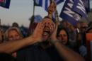 A demonstrator shouts slogans during a rally organized by supporters of the Yes vote in Athens, Friday, July 3, 2015. A new opinion poll shows a dead heat in Greece's referendum campaign with just two days to go before Sunday's vote on whether Greeks should accept more austerity in return for bailout loans. (AP Photo/Emilio Morenatti)