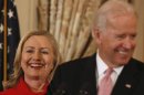 U.S. Secretary Clinton listens to Vice President Biden at State Department in Washington