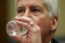Michigan Governor Rick Snyder drinks some water as he testifies for Flint Michigan water hearing on Capitol in Washington