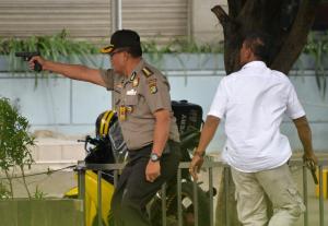 An Indonesian policeman fires his handgun towards suspects&nbsp;&hellip;