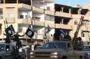 An image made available by Jihadist media outlet Welayat Raqa on June 30, 2014, allegedly shows members of the IS (Islamic state) militant group parading in a street in the northern rebel-held Syrian city of Raqa