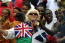 Jimmy Savile joins people from Commonwealth countries in tradional dress outside Buckingham Palace in London on June 4, 2002