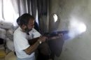 A Free Syrian Army fighter fires his weapon in Aleppo