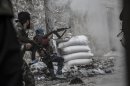 In this Wednesday, Oct. 24, 2012 photo, a rebel fighter retreats for cover as enemy fire targets the rebel position during clashes at the Moaskar front line, one of the battlefields in the Karmal Jabl neighborhood, of Aleppo, Syria. (AP Photo/Narciso Contreras).