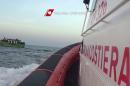 In this video grab released by the Italian Coast Guard (Guardia Costiera) on May 6, 2015 migrants gesture on a boat before a rescue operation