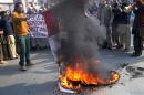 Pakistani protesters burn a French flag during a demonstration against cartoons of the Prophet Mohammad by French magazine Charlie Hebdo, on January 15, 2015 in Multan