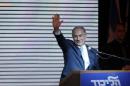 Israeli Prime Minister Netanyahu gestures to supporters at party headquarters in Tel Aviv