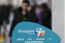 A man makes a phone call near a Bouygues Telecom company shop in Nice
