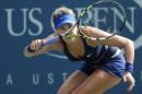 Eugenie Bouchard, of Canada, returns a shot against Ekaterina Makarova, of Russia, during the fourth round of the 2014 U.S. Open tennis tournament, Monday, Sept. 1, 2014, in New York. (AP Photo/John Minchillo)