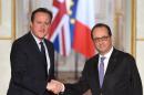 French President Francois Hollande (right) shakes hands with British Prime Minister David Cameron following anti-terror talks at the Elysee Palace in Paris on November 23, 2015