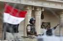 Security personnel watch over supporters of former Egyptian President Mursi during a demonstration outside the Republican Guard building in Cairo