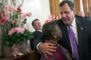 New Jersey governor Chris Christie hugs a woman at a statewide prayer service held at The New Hope Baptist Church in Newark, N.J., on Tuesday, Oct. 29, 2013, the one-year anniversary of Superstorm Sandy. Christie made a number of stops throughout the state commemorating the first anniversary of the powerful storm that tore through the state, leaving more than 340,000 homes either damaged or destroyed and 71 deaths in its wake. (AP Photo/Eric Thayer, Pool)