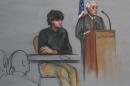 In this Monday, Jan. 5, 2015, file courtroom sketch, Boston Marathon bombing suspect Dzhokhar Tsarnaev, left, is depicted beside U.S. District Judge George O'Toole Jr., right, as O'Toole addresses a pool of potential jurors in a jury assembly room at the federal courthouse, in Boston. Lawyers for Boston Marathon bombing suspect Dzhokhar Tsarnaev asked a judge on Tuesday, Jan. 13, to suspend jury selection in his trial for at least a month because the recent terrorist attacks in France have again placed the marathon bombings "at the center of a grim global drama." (AP Photo/Jane Flavell Collins, File)