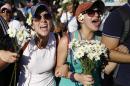 Supporters of opposition leader Leopoldo Lopez hold flowers and shout during a rally to promote peace in Caracas