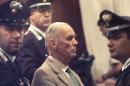 Ex-Nazi captain Erich Priebke, then 83, is surrounded by Italian police on August 1, 1996, in a military court in Rome