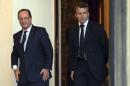 File photo of French President Hollande and economy advisor Emmanuel Macron who walk in the Elysee Palace in Paris