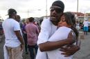 Shawn Letchaw hugs a woman named Marie, who didn't give her last name, at the scene where a black man was shot by police earlier in El Cajon, east of San Diego, Calif., Tuesday, Sept. 27, 2016. (Hayne Palmour IV/The San Diego Union-Tribune via AP)