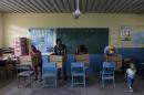 Residents prepare their ballots in voting booths during the presidential election at a polling station in Panama City