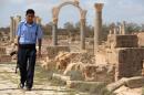 A Libyan officer with the tourist police patrols the Roman Temple in Sabratha on September 6, 2011