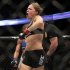 Ronda Rousey celebrates defeating Liz Carmouche after their UFC 157 women's bantamweight championship mixed martial arts match in Anaheim, Calif., Saturday, Feb. 23, 2013. Rousey won the first women’s bout in UFC history, forcing Carmouche to tap out in the first round. (AP Photo/Jae C. Hong)
