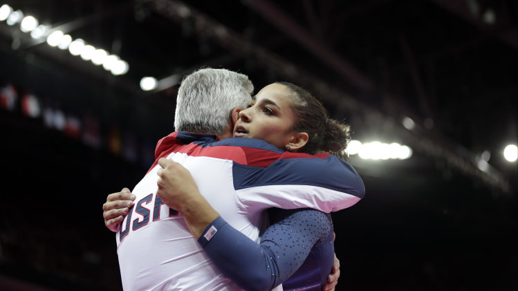 U.S. gymnast Alexandra Raisman hugs coach M