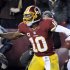 Washington Redskins quarterback Robert Griffin III (10) celebrates his touchdown during the second half of an NFL football game against the Dallas Cowboys on Sunday, Dec. 30, 2012, in Landover, Md. (AP Photo/Nick Wass)