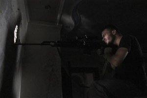 A Free Syrian Army sniper is seen in shooting position …