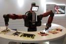 A Baxter robot of Rethink Robotics picks up a business card as it performs during display at the World Economic Forum, in China's port city Dalian