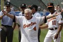 FILE - In this Saturday, June 26, 2010 file photo, former Baltimore Orioles manager Earl Weaver (4) waves to the crowd after taking the lineup card out before the start of a baseball game between the Orioles and Washington Nationals, in Baltimore, as members of the Orioles' 1970 team were honored before the start of the game. At right is interim manager Juan Samuel (11). Weaver, the fiery Hall of Fame manager who won 1,480 games with the Baltimore Orioles, has died, the team announced Saturday, Jan. 19, 2013. He was 82. (AP Photo/Rob Carr, File)