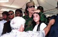 FILE - In this undated 1996 file photo, Col. Moammar Gadhafi holds his daughter Hana in Tripoli, Libya. Since the rebel takeover of Tripoli, evidence has been mounting that Moammar Gadhafi lied about the death of his adopted baby daughter Hana in a 1986 American airstrike. (AP Photo/Lino Azzopardi, File)