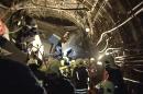 In this frame grab from video provided by the Russian Ministry for Emergency Situations, rescue teams work inside the tunnel in Moscow where a rush-hour subway train derailed Tuesday, July 15, 2014, killing at least 20 people and sending 150 others to the hospital, many with serious injuries, Russian officials said. Officials vigorously dismissed terrorism as a possible cause. (AP Photo/Russian Emergency Situation Ministry)