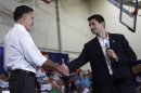 U.S. Republican presidential candidate Romney shakes hands with his vice presidential candidate Ryan in Ashland