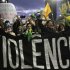 Demonstrators shout anti-government slogans behind a banner during one of many protests around Brazil's major cities in Sao Paulo