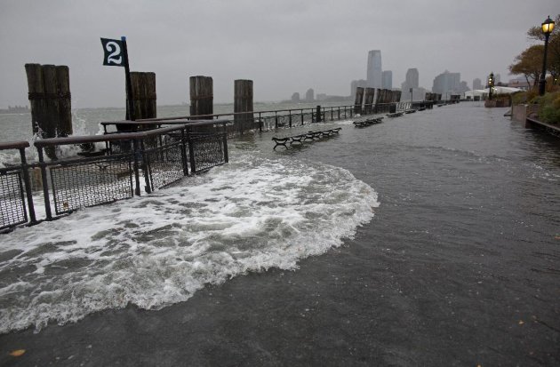 Waves wash over the seawall near high tide at Battery Park in New York, Monday, Oct. 29, 2012, as Hurricane Sandy approaches the East Coast. (AP Photo/Craig Ruttle)