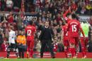 Liverpool's manager Brendan Rodgers, centre, celebrates with his players after their 4-0 win against Tottenham in their English Premier League soccer match at Anfield Stadium, Liverpool, England, Sunday March 30, 2014. (AP Photo/Jon Super)