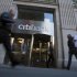 Passersby walk in front of a Citibank branch in New York