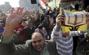 People shout slogans against the military and interior ministry during an Islamist protest in the Cairo suburb of Matariya