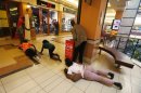 People scramble for safety as armed police hunt gunmen who went on a shooting spree at Westgate shopping centre in Nairobi