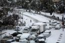 Vehicles are seen stranded in snow at the entrance of Jerusalem on December 13, 2013 following a snowstorm