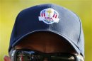 The golf course is reflected in the sunglasses of U.S. captain Love III as he walks along the 11th fairway during the afternoon four-ball round at the 39th Ryder Cup golf matches at the Medinah Country Club